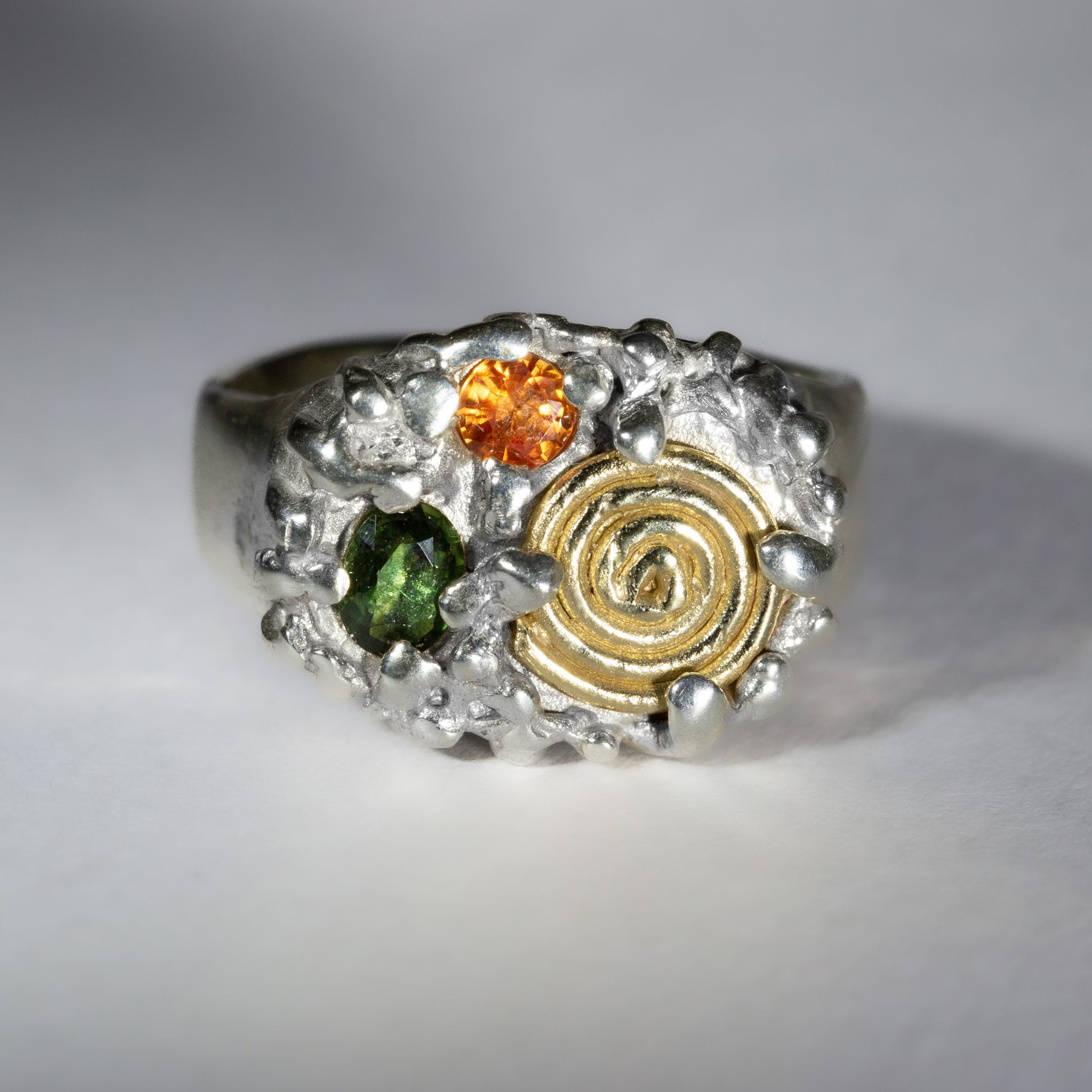 gold spiral finger rings. spiral finger ring.gold and silver alloy jewelry two tone silver and gold jewelry handmade jewellery shop london handmade gold jewellery london rainbow colored stone ring handmade jewellery united kingdom sapphire swirl.