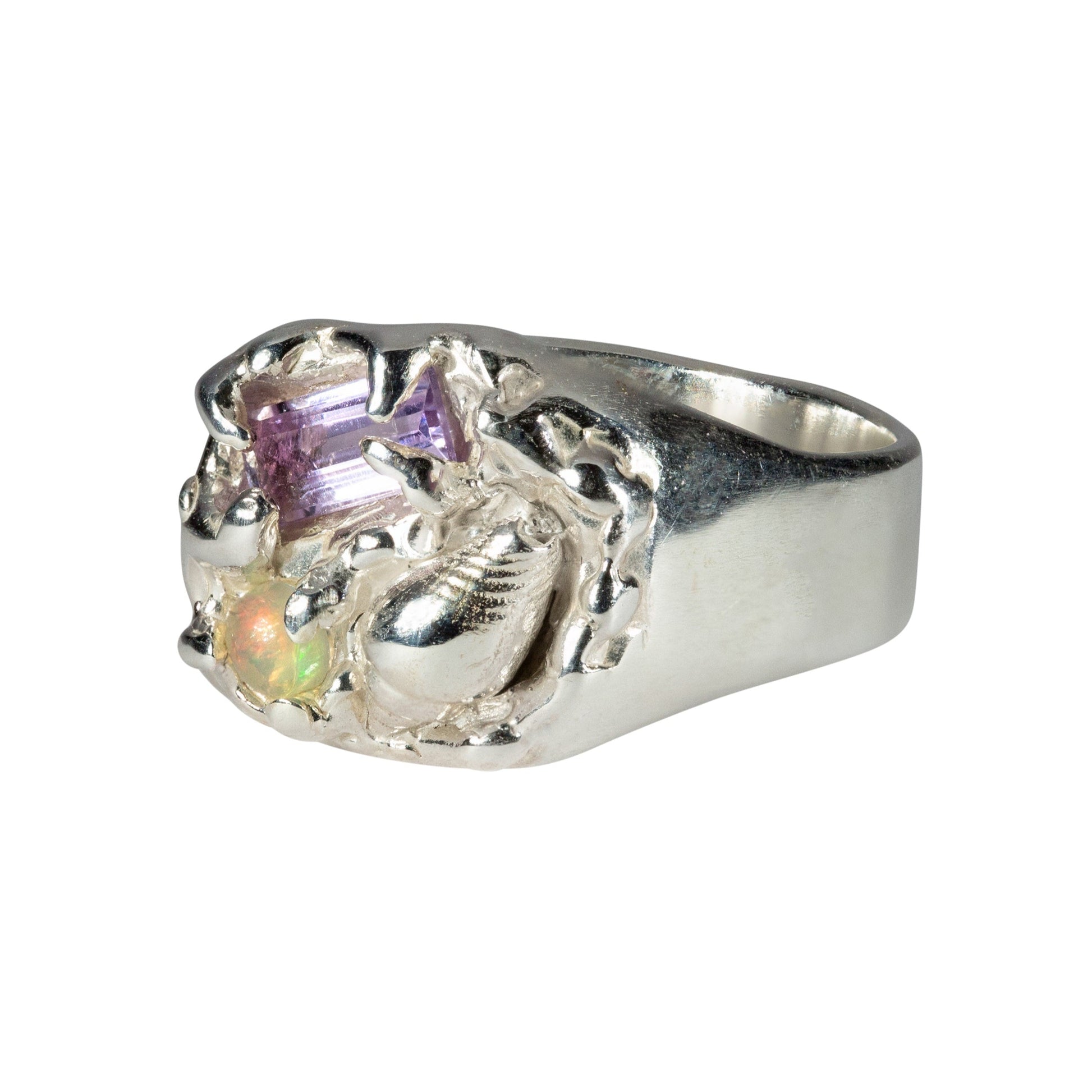 Silver ring with opal and amethyst on a white background