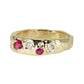 Gold ring with red gemstones and small diamonds on a white background